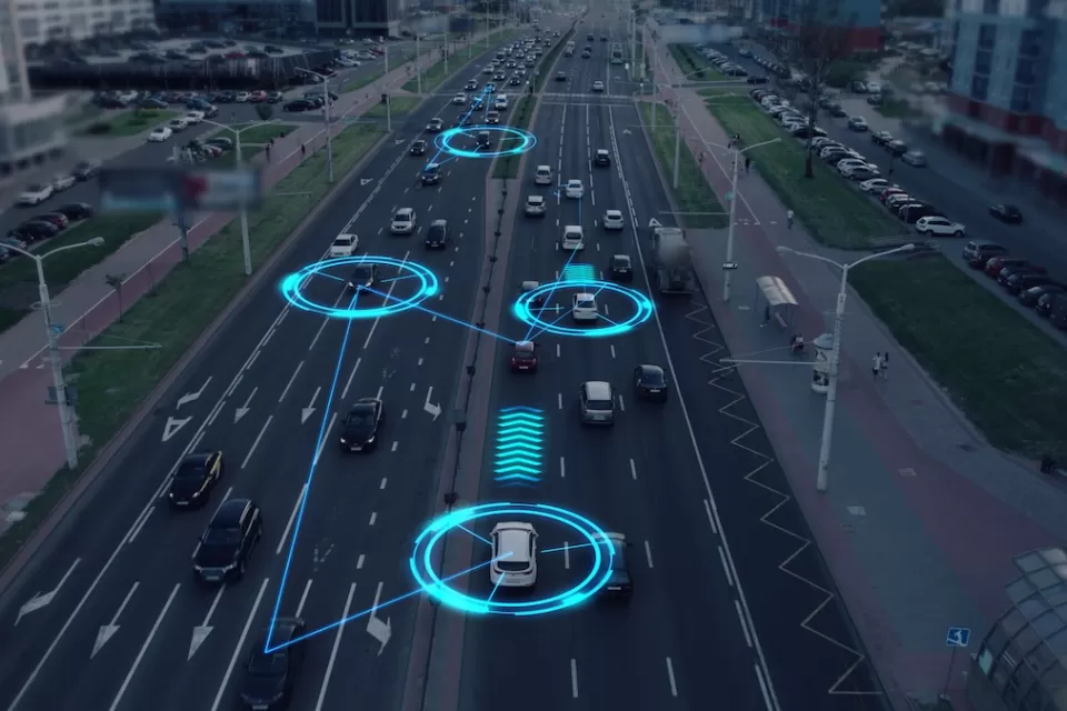 Image of cars driving on multi-lane road with graphics indicating the vehicles are communicating with each other.